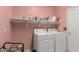 Convenient laundry room with washer, dryer, and ample shelf storage at 18402 E Oak Hill Ln, Queen Creek, AZ 85142