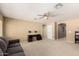Spacious living room with neutral walls and carpeted floor, and a ceiling fan at 18402 E Oak Hill Ln, Queen Creek, AZ 85142