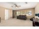Comfortable living room with a ceiling fan, neutral walls, and carpeted floor at 18402 E Oak Hill Ln, Queen Creek, AZ 85142