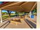 Covered picnic area with multiple concrete picnic tables, providing a comfortable space for outdoor gatherings and dining at 18402 E Oak Hill Ln, Queen Creek, AZ 85142