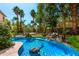 Backyard paradise featuring a lagoon pool, lush landscaping, and a rock waterfall at 18402 E Oak Hill Ln, Queen Creek, AZ 85142