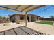 Backyard with patio cover, pavers, built-in grill and artificial grass at 18617 W Williams St, Goodyear, AZ 85338