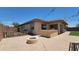 Backyard featuring a built-in grill, artificial grass and pavers at 18617 W Williams St, Goodyear, AZ 85338