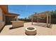 Backyard featuring pavers, a built-in grill, patio cover and a firepit at 18617 W Williams St, Goodyear, AZ 85338