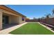 An artificial lawn is surrounded by brick pavers and landscape lighting at 18617 W Williams St, Goodyear, AZ 85338