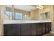 Bathroom featuring a large mirror and dual sink vanity at 18617 W Williams St, Goodyear, AZ 85338