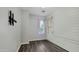 Bright bedroom with wood-look flooring, white shiplap accent wall and soft natural light through the windows at 18617 W Williams St, Goodyear, AZ 85338