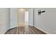 Bedroom with wood grain flooring, white walls and double doors leading to an adjacent room at 18617 W Williams St, Goodyear, AZ 85338