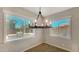 Bright dining area with stylish chandelier and views of outdoor grill at 18617 W Williams St, Goodyear, AZ 85338