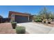 Single-story home with desert landscaping and a driveway at 18617 W Williams St, Goodyear, AZ 85338
