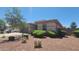 Single-story home with desert landscaping and trimmed bushes at 18617 W Williams St, Goodyear, AZ 85338