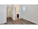 Hallway with luxury vinyl floors leading to a bathroom, bedroom and other rooms in the home at 18617 W Williams St, Goodyear, AZ 85338