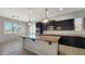 Open kitchen with a granite counter island and stainless steel appliances at 18617 W Williams St, Goodyear, AZ 85338