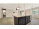 Kitchen island with sink, pendant lights, and stainless steel dishwasher at 18617 W Williams St, Goodyear, AZ 85338