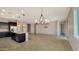Open living space featuring a kitchen island and modern lighting fixtures at 18617 W Williams St, Goodyear, AZ 85338