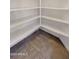Walk-in pantry with tile floor and white shelves at 18617 W Williams St, Goodyear, AZ 85338