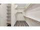 Walk-in closet featuring built-in shelving and laminate floors at 18617 W Williams St, Goodyear, AZ 85338