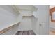Spacious walk-in closet with wooden rods and white shelving for ample storage and organization at 18617 W Williams St, Goodyear, AZ 85338