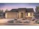 Charming single-story home showcasing stone accents, a two-car garage, and desert landscaping at 18683 N 268Th Ave, Buckeye, AZ 85396