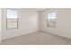This carpeted bedroom features two windows, providing ample natural light and a view of the neighborhood at 18778 E Panchito Dr, Gold Canyon, AZ 85118