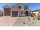 Inviting two-story home with a two-car garage, low-maintenance landscaping, and a welcoming front porch entry at 18778 E Panchito Dr, Gold Canyon, AZ 85118