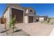 Elegant home showcases a three-car garage and a paved driveway, adding to its curb appeal at 18778 E Panchito Dr, Gold Canyon, AZ 85118