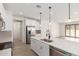 Well-lit kitchen with an island, stainless steel appliances, and an open layout connecting to the living area at 18778 E Panchito Dr, Gold Canyon, AZ 85118