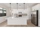 Open-concept kitchen featuring a center island, white cabinets, stainless steel appliances, and stylish pendant lights at 18778 E Panchito Dr, Gold Canyon, AZ 85118