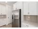 Kitchen area showcasing stainless steel refrigerator, white cabinets, sleek countertops, and modern appliances at 18778 E Panchito Dr, Gold Canyon, AZ 85118