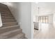 View from stairway into a large living area and an open kitchen concept with stainless steel dishwasher at 18778 E Panchito Dr, Gold Canyon, AZ 85118