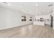 Open-concept living space with modern flooring, ample natural light, and a view of the kitchen and dining area at 18778 E Panchito Dr, Gold Canyon, AZ 85118