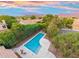 Aerial view of the property featuring a pool, backyard seating, and surrounding landscape at sunset at 19275 N 88Th Way, Scottsdale, AZ 85255