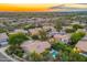 Aerial view of the community featuring multiple homes, landscape, and views of the surrounding desert at sunset at 19275 N 88Th Way, Scottsdale, AZ 85255