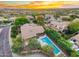 Aerial view of the property featuring a pool and beautiful views of the community at sunset at 19275 N 88Th Way, Scottsdale, AZ 85255
