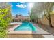 Private backyard oasis with a sparkling pool, a desert landscape, and mature trees at 19275 N 88Th Way, Scottsdale, AZ 85255
