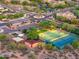 Community aerial view of tennis, basketball courts, playgrounds, and lush greenery, nestled in a desert landscape at 19275 N 88Th Way, Scottsdale, AZ 85255