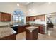 Gourmet kitchen featuring granite counters, stainless appliances, and views of the backyard at 19275 N 88Th Way, Scottsdale, AZ 85255