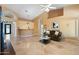Open-concept living area features tile floors, high ceilings, a wet bar, and comfortable seating at 19275 N 88Th Way, Scottsdale, AZ 85255