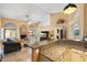 Open-concept living area featuring tile floors, a fireplace, high ceilings, and views to the kitchen at 19275 N 88Th Way, Scottsdale, AZ 85255
