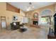 Comfortable living room featuring travertine floors, fireplace, ceiling fan, and large windows with shutters at 19275 N 88Th Way, Scottsdale, AZ 85255
