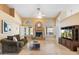 Bright living room featuring travertine floors, a cozy fireplace, and large windows with shutters at 19275 N 88Th Way, Scottsdale, AZ 85255