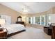 Spacious main bedroom featuring natural light, a ceiling fan, and neutral decor at 19275 N 88Th Way, Scottsdale, AZ 85255