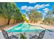 Inviting private backyard pool surrounded by lush landscaping and lounging chairs at 19275 N 88Th Way, Scottsdale, AZ 85255