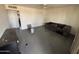 The living room has painted concrete floors and a ceiling fan at 2007 W Roeser Rd, Phoenix, AZ 85041