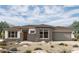 Stunning single-story home with desert landscaping and a brick-accented facade at 20633 W Berridge Ln, Buckeye, AZ 85396