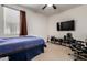 Bedroom with a bed, desk, and mounted TV at 2391 S 171St Ln, Goodyear, AZ 85338