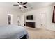 Large main bedroom with a ceiling fan and views of the bathroom and walk-in closet at 2391 S 171St Ln, Goodyear, AZ 85338