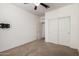 Bright carpeted bedroom featuring a closet with white doors and ceiling fan at 2391 S 171St Ln, Goodyear, AZ 85338