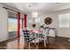Dining area with a round glass table, chairs, modern decor and sliding door access to patio at 2391 S 171St Ln, Goodyear, AZ 85338