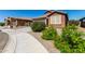 Charming single-story home featuring a well-maintained yard, landscaping and a two-car garage at 2391 S 171St Ln, Goodyear, AZ 85338